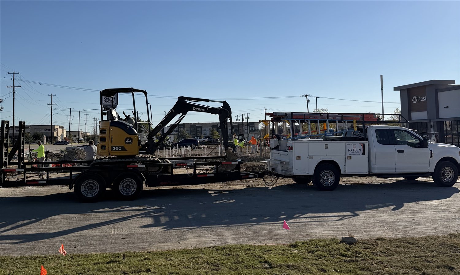 NXTGEN truck hauling excavator